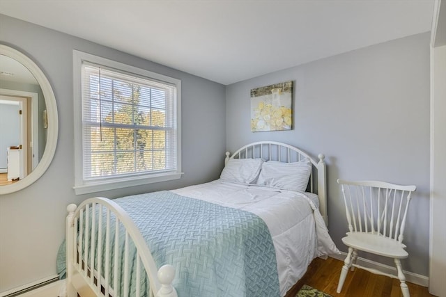 bedroom with hardwood / wood-style flooring and a baseboard radiator