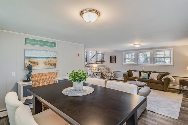 dining area with a baseboard heating unit and wood-type flooring