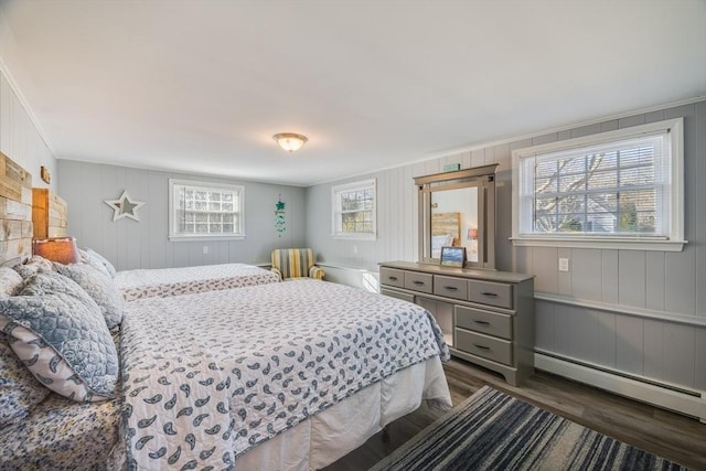 bedroom featuring a baseboard radiator, dark wood-type flooring, and crown molding