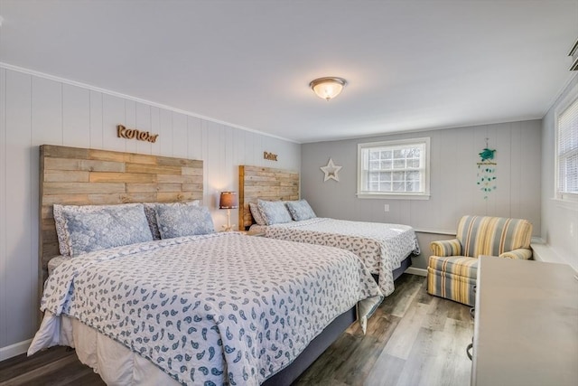 bedroom with hardwood / wood-style flooring and crown molding