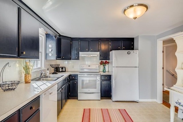 kitchen featuring sink, white appliances, and backsplash