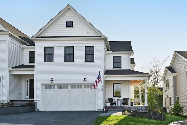 11 Bailey Pond Ln Unit 11, Amesbury, MA 01913 - view of front of property featuring a porch, asphalt driveway, a garage, and roof with shingles