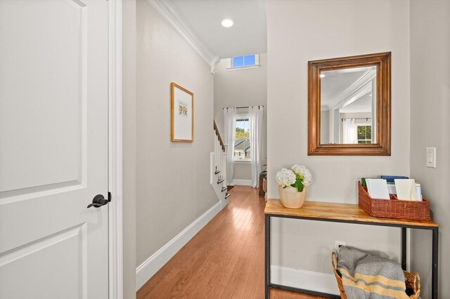 11 Bailey Pond Ln Unit 11, Amesbury, MA 01913 - corridor featuring light wood-type flooring, baseboards, stairway, ornamental molding, and recessed lighting