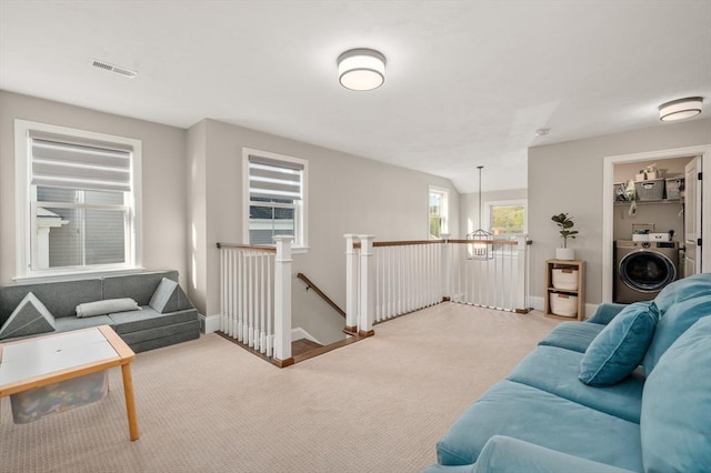11 Bailey Pond Ln Unit 11, Amesbury, MA 01913 - carpeted living room featuring washer / dryer and baseboards
