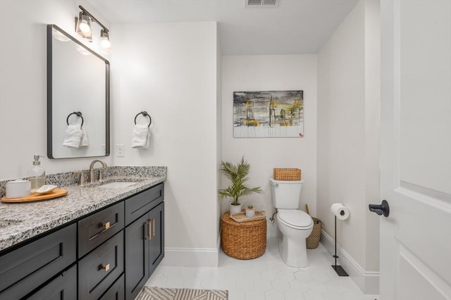 11 Bailey Pond Ln Unit 11, Amesbury, MA 01913 - bathroom with vanity, toilet, baseboards, and tile patterned flooring