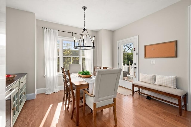 11 Bailey Pond Ln Unit 11, Amesbury, MA 01913 - dining room with a chandelier, plenty of natural light, light wood-style floors, and baseboards
