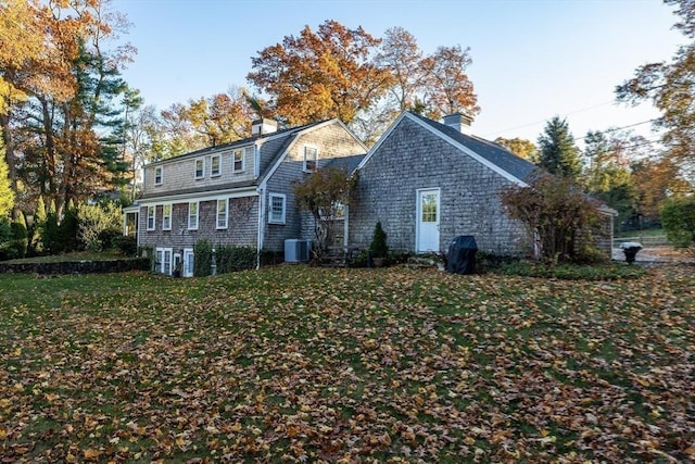 view of front of home featuring a front yard and central air condition unit