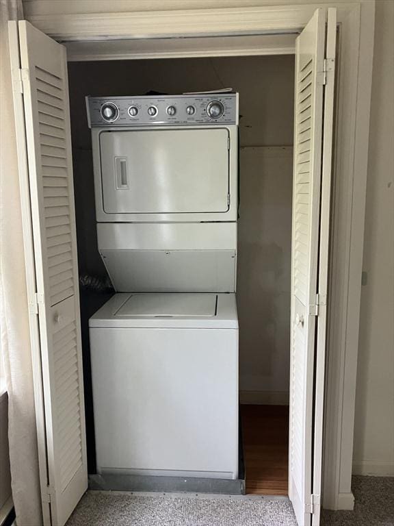 14 Harold St Unit D, Harwich, MA 02646 - washroom with stacked washer and clothes dryer and ornamental molding