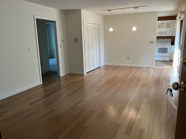 14 Harold St Unit D, Harwich, MA 02646 - empty room with wood finished floors and a textured ceiling