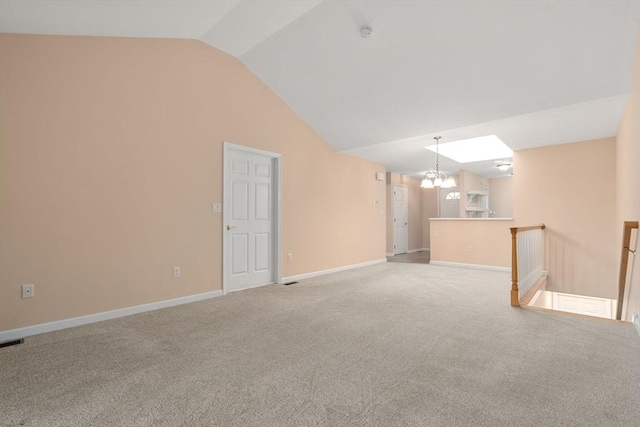 23 William Onthank Ln Unit 23, Southborough, MA 01772 - unfurnished living room with a chandelier, lofted ceiling, carpet floors, and baseboards