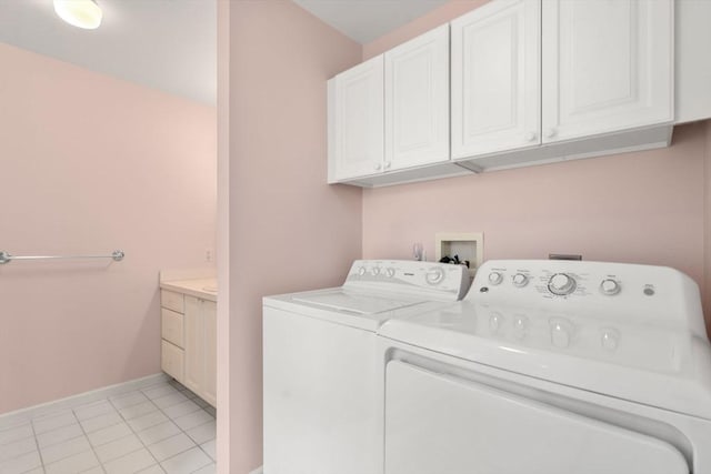23 William Onthank Ln Unit 23, Southborough, MA 01772 - washroom featuring washing machine and clothes dryer, cabinet space, baseboards, and light tile patterned flooring