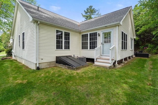 23 William Onthank Ln Unit 23, Southborough, MA 01772 - back of house featuring entry steps, a yard, roof with shingles, and central AC unit
