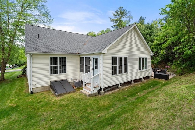 23 William Onthank Ln Unit 23, Southborough, MA 01772 - back of property featuring roof with shingles, a lawn, and cooling unit