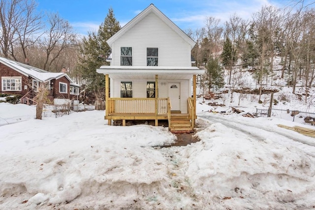 view of front of home with fence and a porch