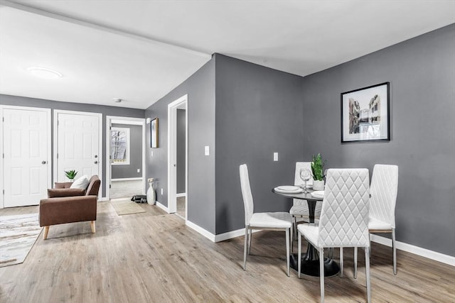 dining room with baseboards and wood finished floors