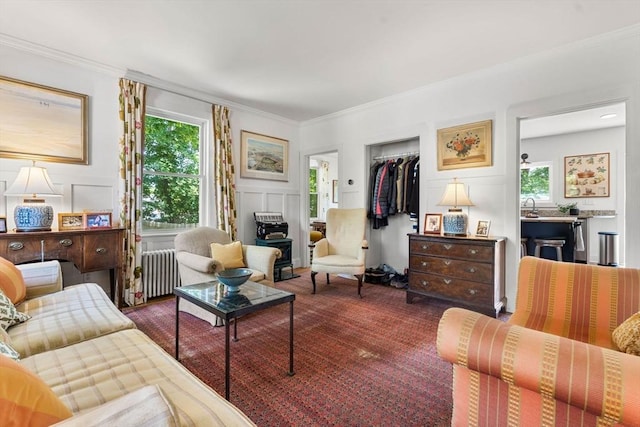250 Arlington St Unit A, Acton, MA 01720 - living area with radiator heating unit, a decorative wall, healthy amount of natural light, and crown molding