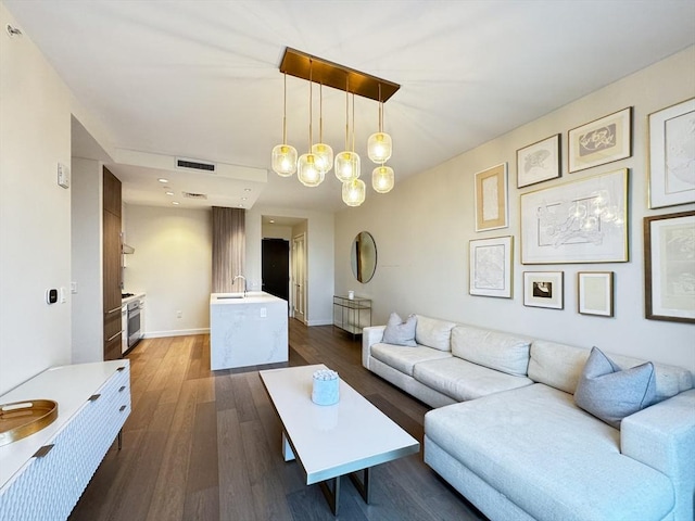 living room with dark wood-type flooring and sink