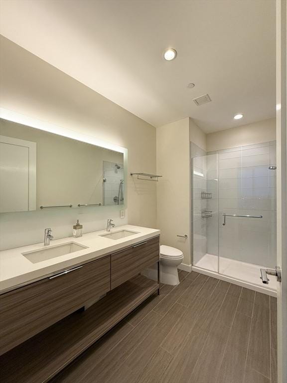 bathroom with vanity, toilet, and walk in shower