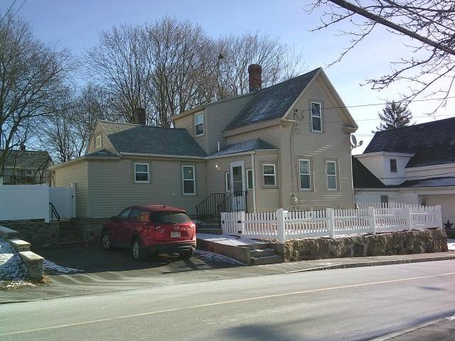 view of front of property with a chimney and fence