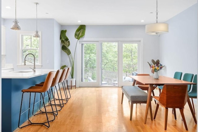 dining area featuring light wood-type flooring and recessed lighting