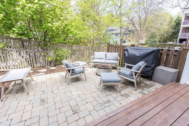 view of patio featuring an outdoor living space, a fenced backyard, and grilling area