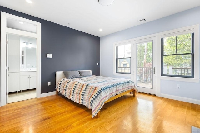 bedroom with light wood finished floors, access to exterior, baseboards, recessed lighting, and ensuite bathroom