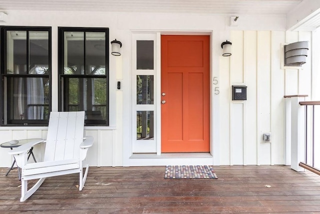 view of exterior entry featuring board and batten siding
