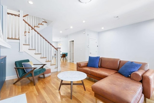 living area with stairway, light wood-type flooring, recessed lighting, and baseboards
