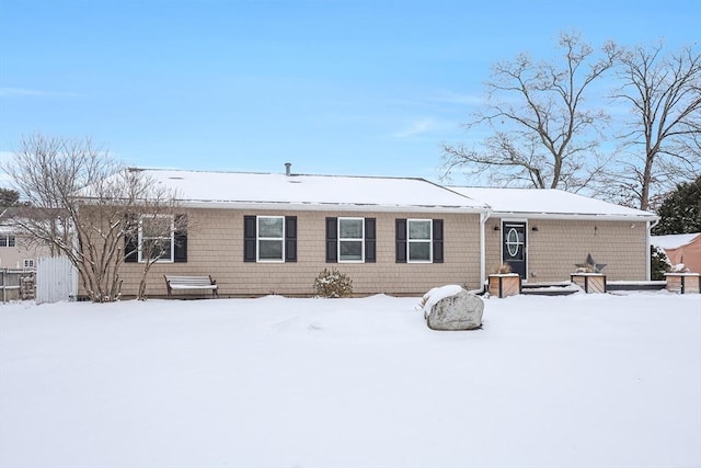 view of snow covered rear of property