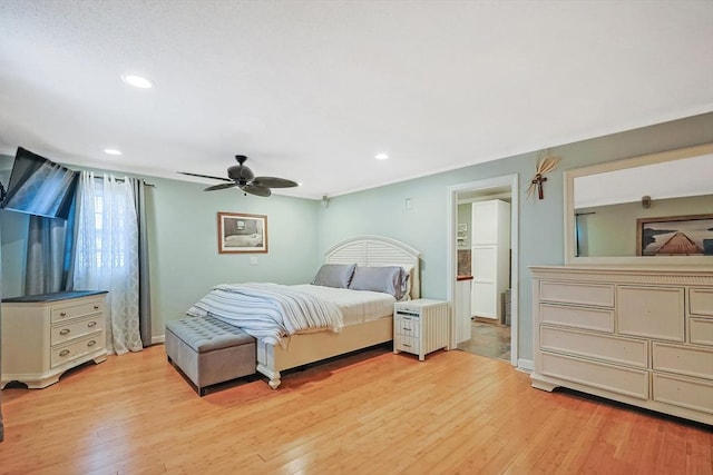 bedroom with ceiling fan and light hardwood / wood-style floors