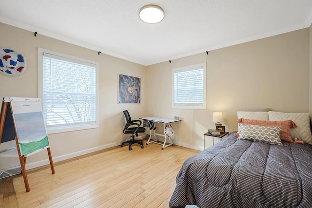 bedroom featuring multiple windows and light wood-type flooring