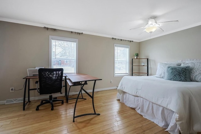 bedroom with ceiling fan, light hardwood / wood-style flooring, multiple windows, and crown molding