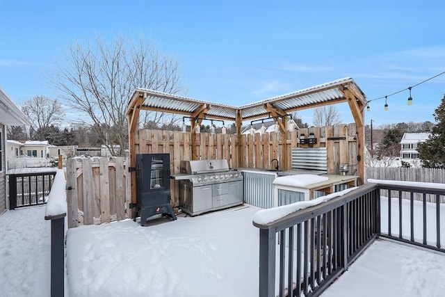 snow covered deck with area for grilling