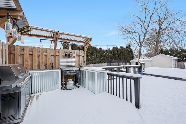 snow covered deck with grilling area