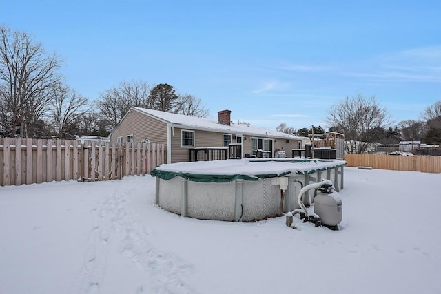 snow covered property featuring a covered pool