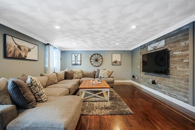 living room with dark hardwood / wood-style flooring and ornamental molding