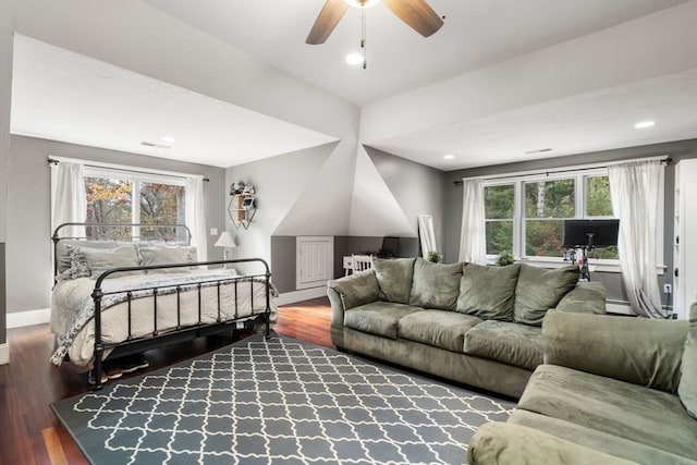 bedroom featuring ceiling fan, baseboard heating, and wood-type flooring