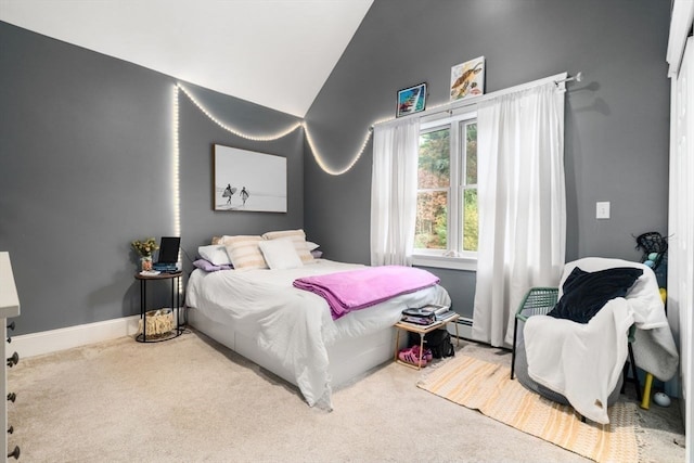 bedroom with carpet flooring and vaulted ceiling