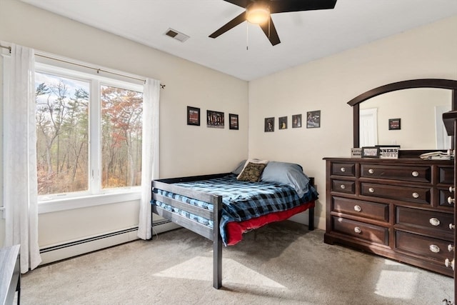 bedroom with ceiling fan, baseboard heating, and light colored carpet