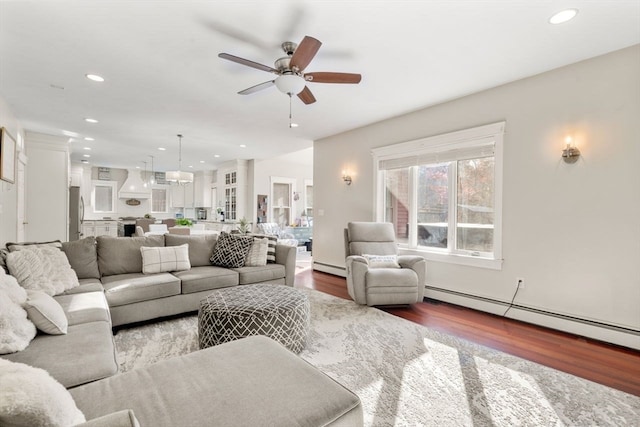 living room with hardwood / wood-style floors, ceiling fan, and a baseboard radiator