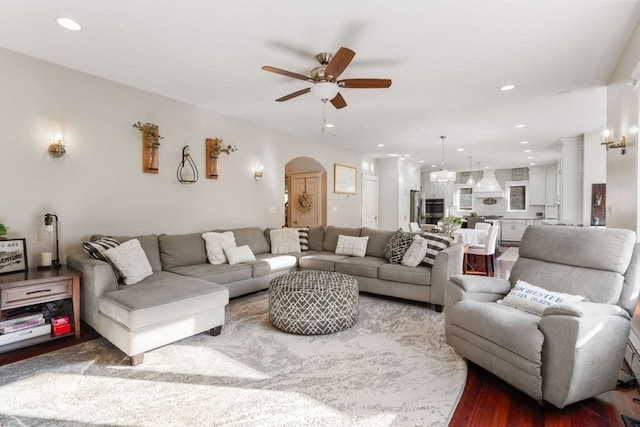 living room with wood-type flooring and ceiling fan