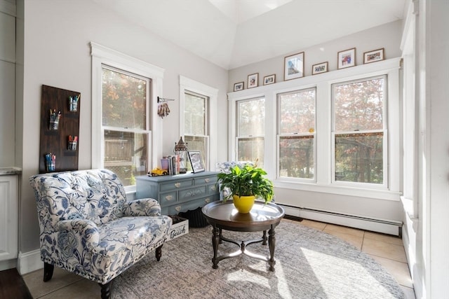 sitting room featuring light tile patterned floors and a baseboard heating unit