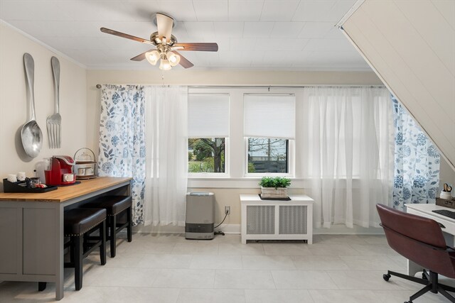 home office featuring crown molding, radiator, light tile patterned floors, and a ceiling fan