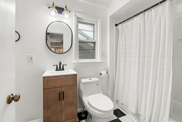 full bath with vanity, shower / bath combo, and toilet