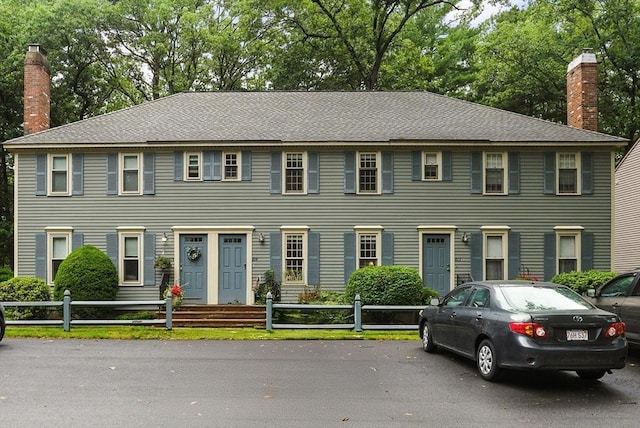 814 Wellman Ave Unit 814, Chelmsford, MA 01863 - colonial-style house featuring a fenced front yard and a chimney