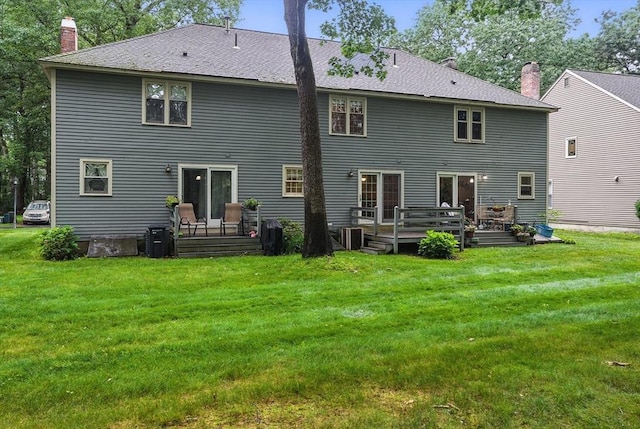 814 Wellman Ave Unit 814, Chelmsford, MA 01863 - back of house with a chimney, a wooden deck, and a lawn