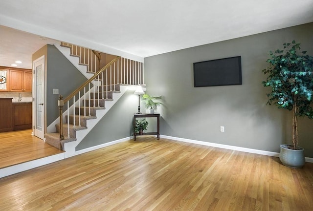 814 Wellman Ave Unit 814, Chelmsford, MA 01863 - unfurnished living room with stairway, light wood-style flooring, and recessed lighting