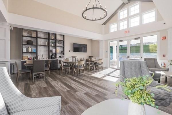 living room featuring high vaulted ceiling, hardwood / wood-style floors, a notable chandelier, and beam ceiling