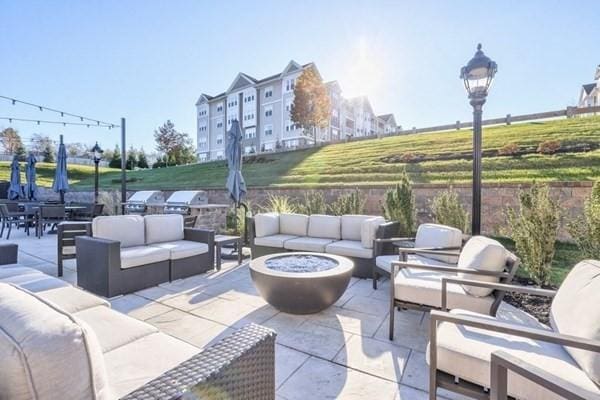 view of patio / terrace with an outdoor living space with a fire pit