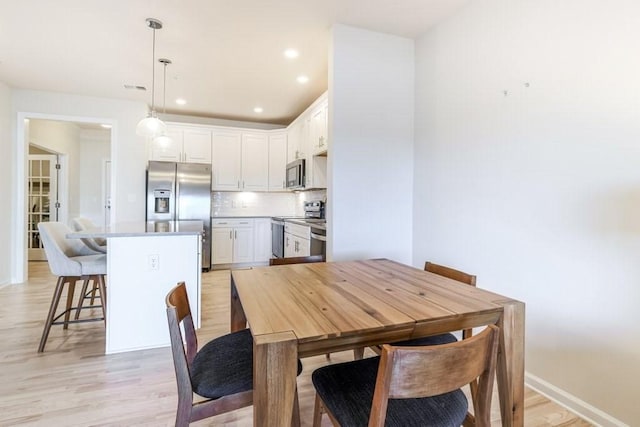 dining space featuring light hardwood / wood-style floors